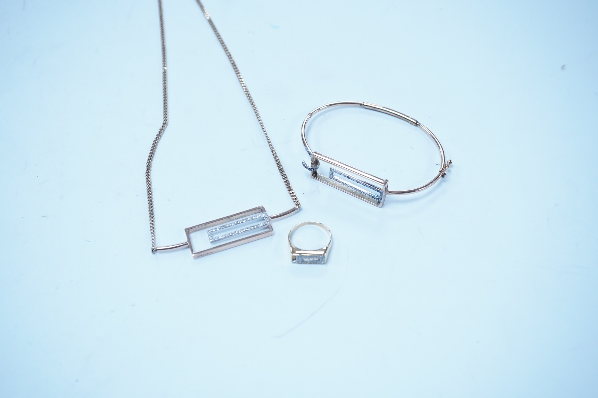 A modern suite of 9ct gold and diamond chip set jewellery, including a ring, bracelet and necklace, 38cm, gross weight 20.8 grams. Condition - fair to good